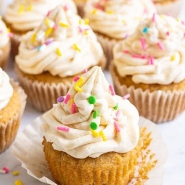 Healthy cupcakes in paper muffin liners with frosting and colorful sprinkles.