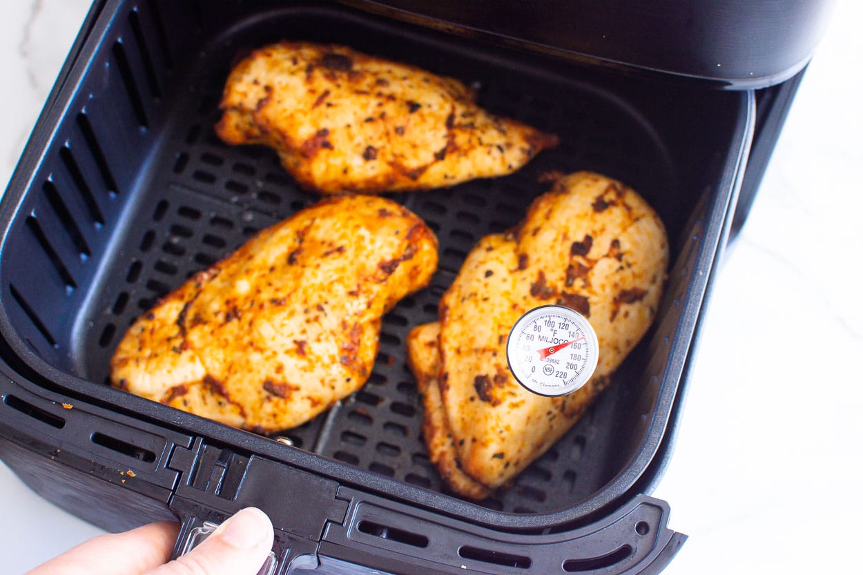 cooked air fryer chicken breasts with thermometer inserted