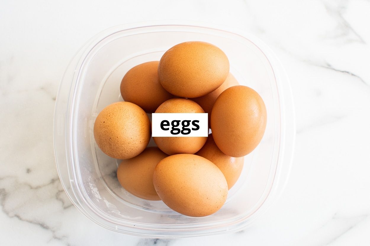 Brown eggs in a plastic container.