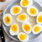 Air fryer hard boiled eggs cut in half on a plate.