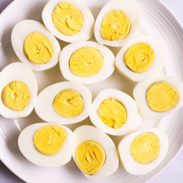 Instant Pot hard boiled eggs sliced on a plate.