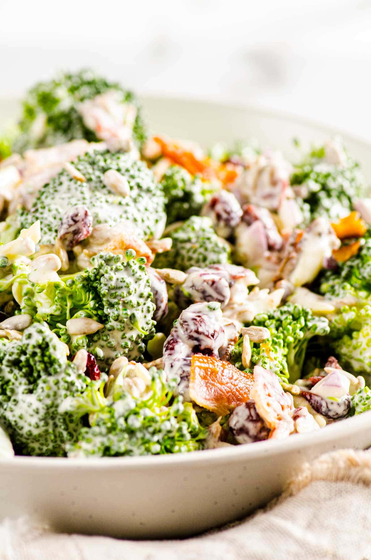 Healthy broccoli salad in white bowl.