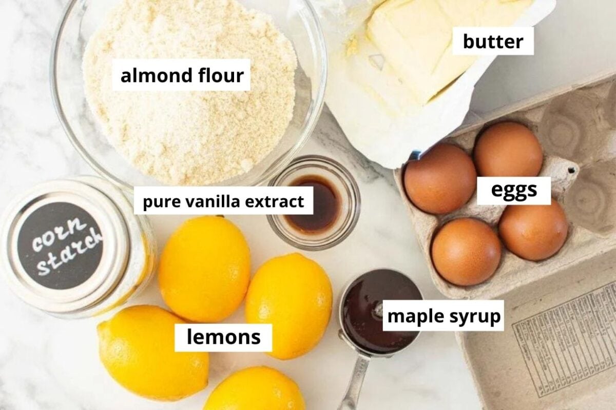 Lemons, almond flour, butter, eggs and maple syrup ingredients.