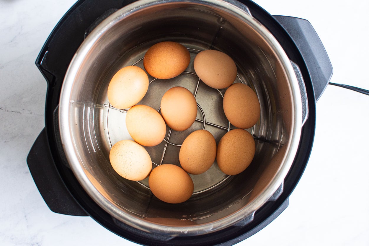 Ten eggs on a trivet inside Instant Pot.