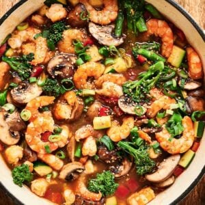 Shrimp stir fry garnished with sesame seeds.