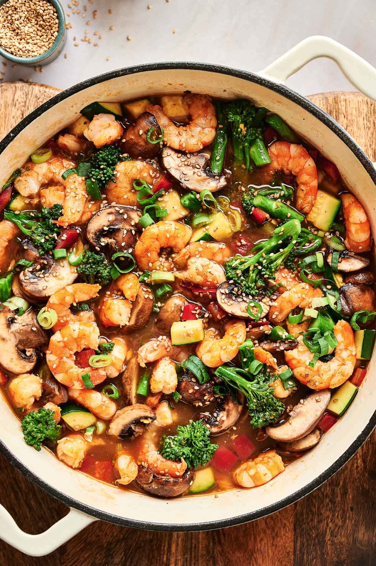 Shrimp stir fry garnished with sesame seeds.