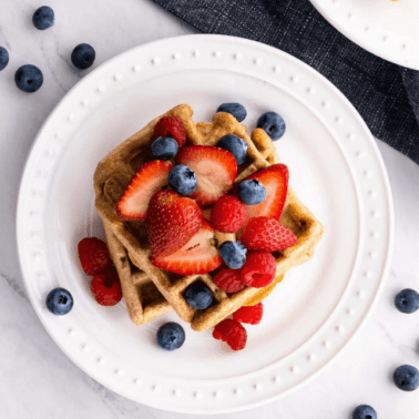 Healthy waffles on a plate with fresh berries.