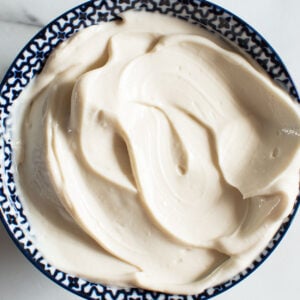 Healthy Greek yogurt frosting in a blue and white bowl.