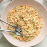 Healthy coleslaw with two forks in a bowl.