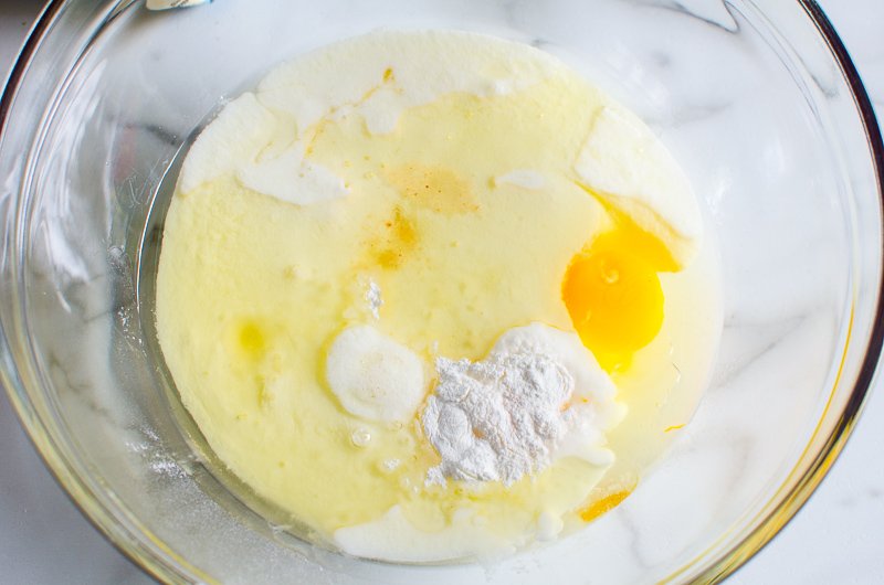 Buttermilk, eggs, oil, maple syrup, baking soda and powder, salt in glass bowl.