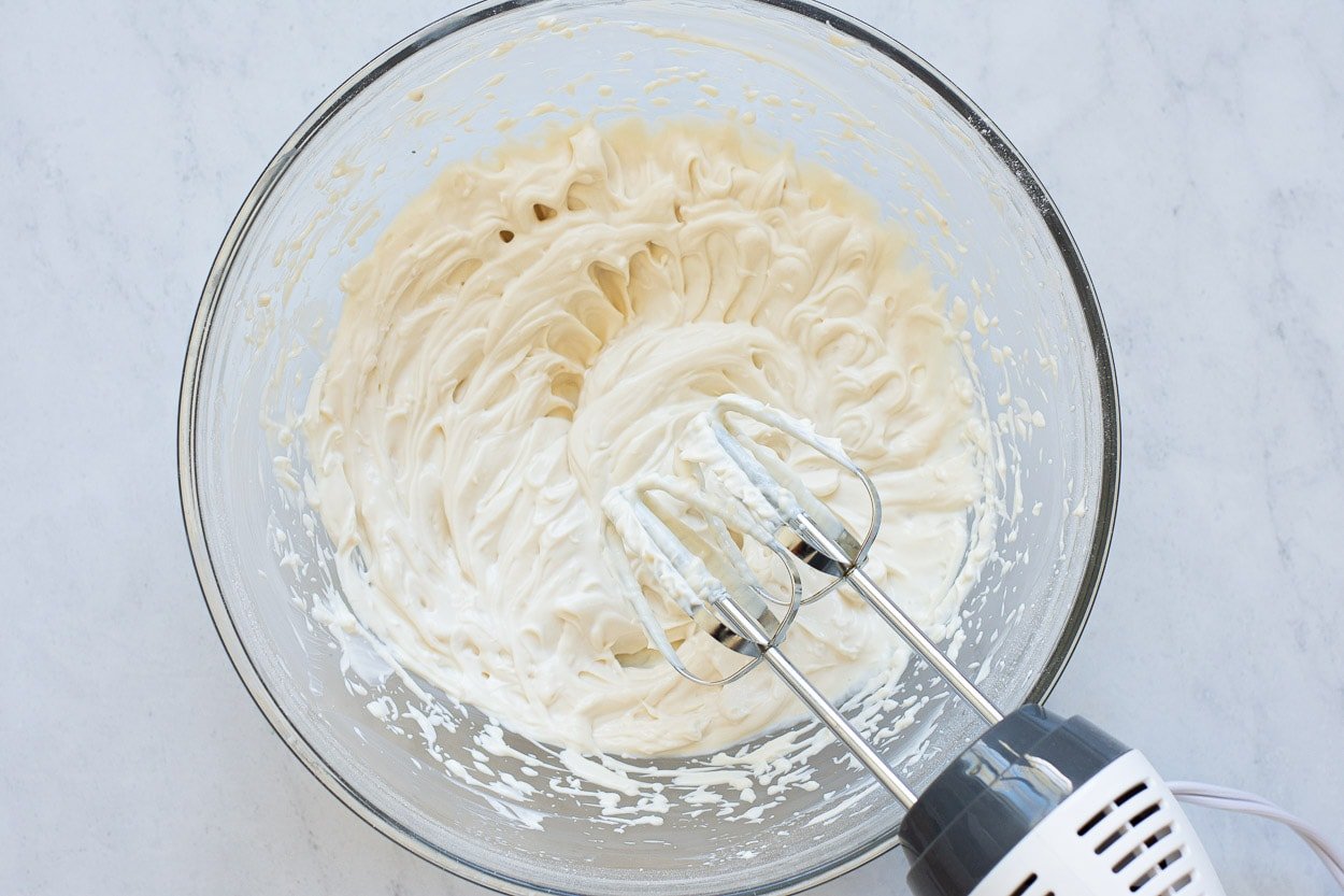 Electric mixer with bowl of icing.