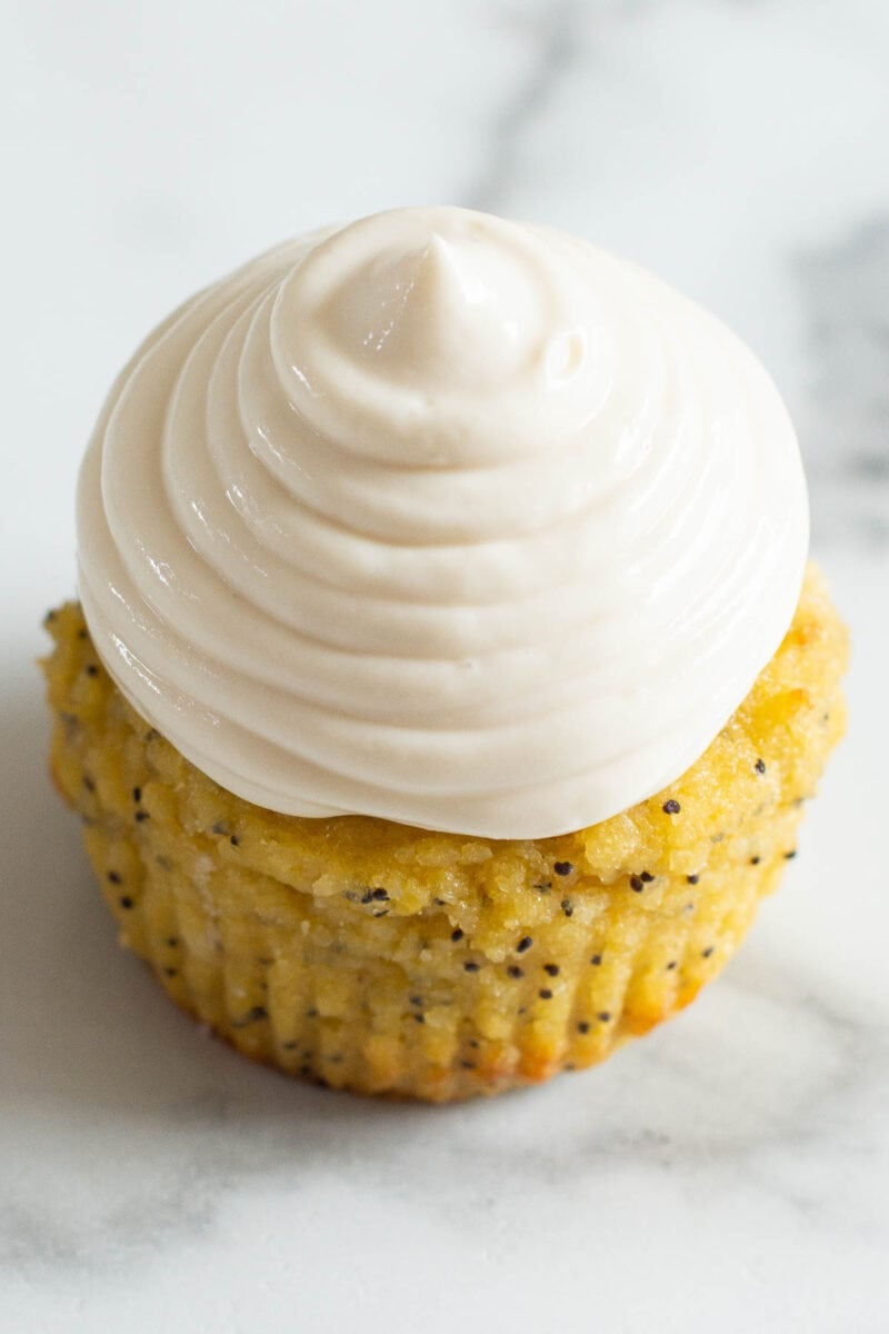 Greek yogurt frosting piped onto lemon poppy seed muffin.