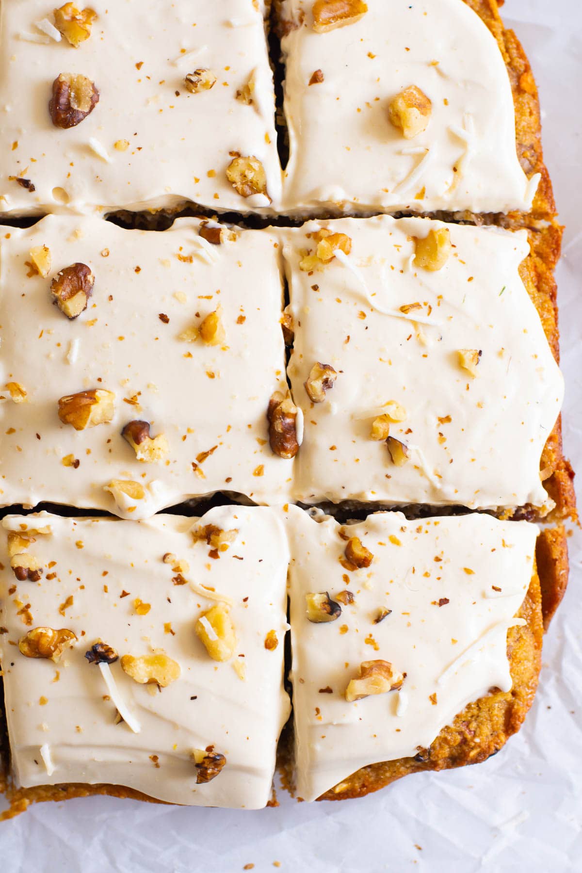 Healthy carrot cake bars iced and cut into square slices.