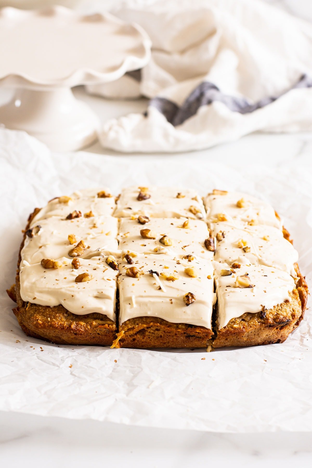 Healthy cream cheese frosting on sliced carrot cake bars.