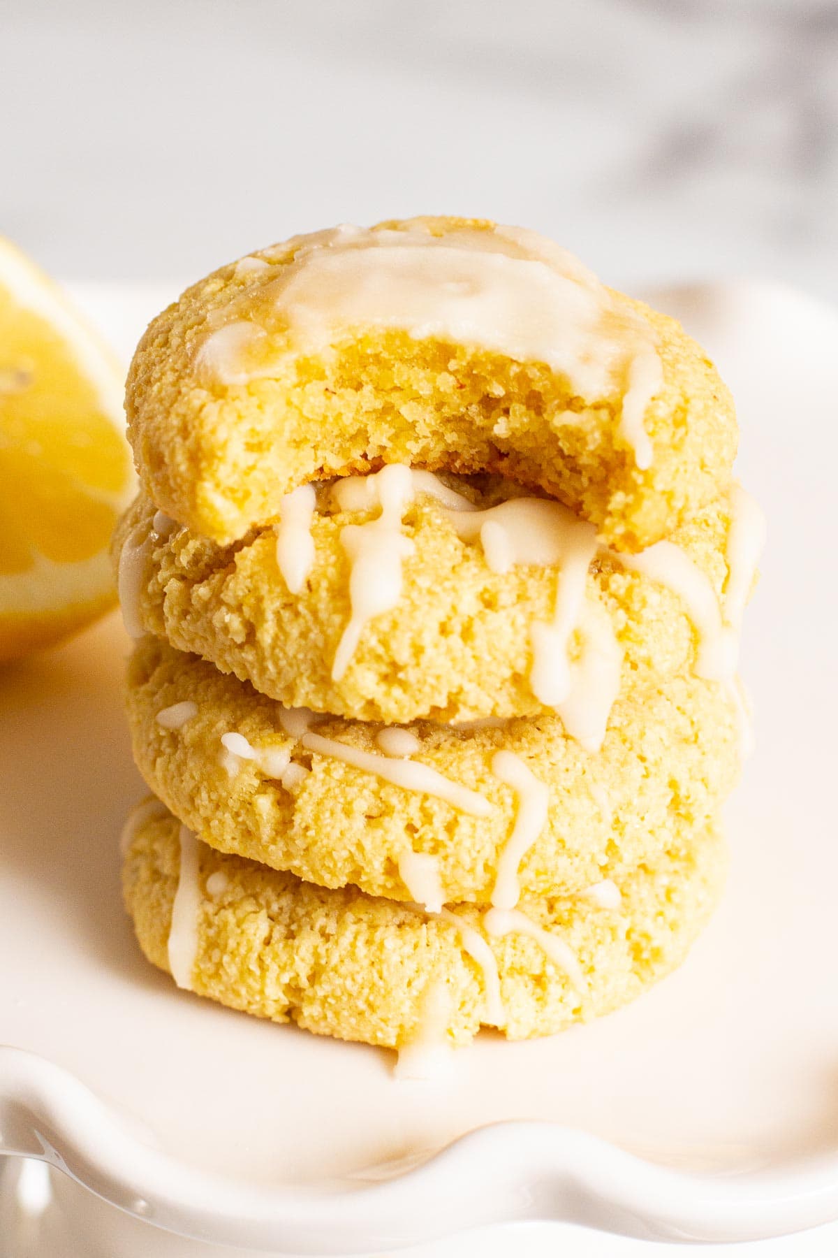 Stack of healthy lemon cookies with a bite out of the one on top.