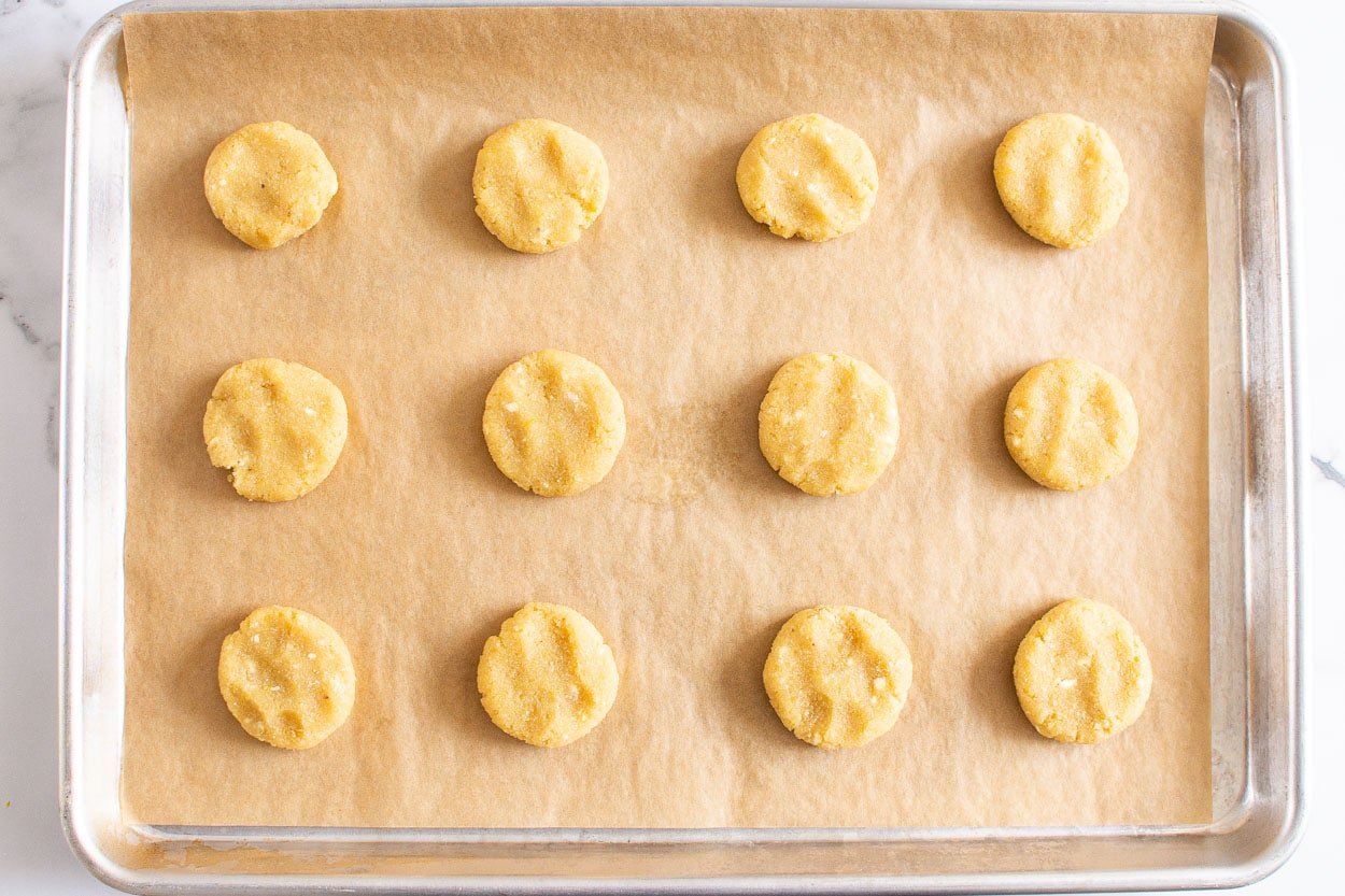 Healthy lemon cookie dough on parchment lined baking sheet.