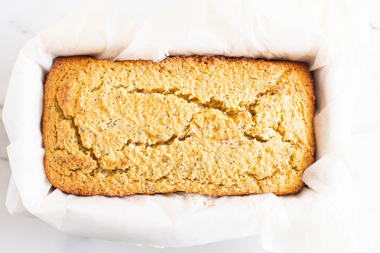 Baked healthy lemon poppy seed bread in loaf pan.