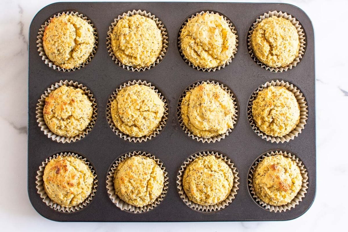 Baked healthy lemon poppy seed muffins in a muffin tin.