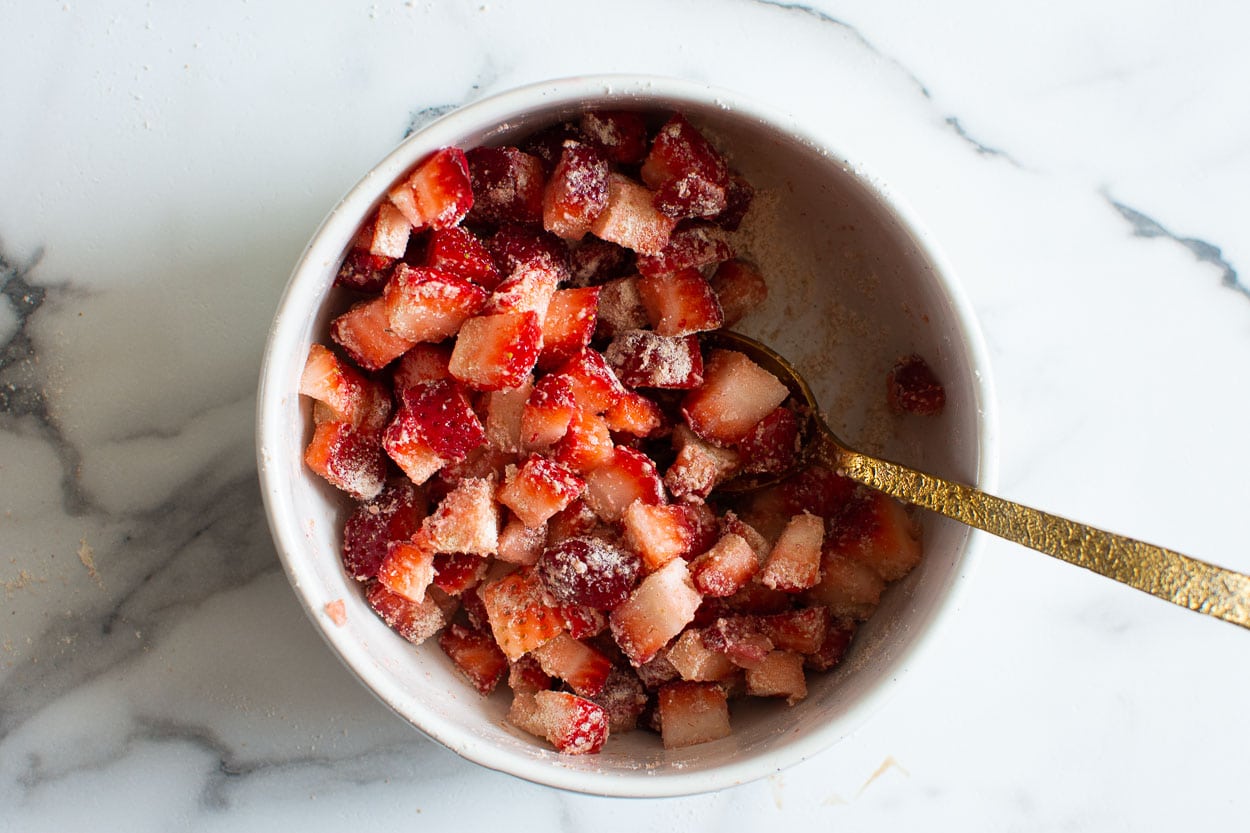 Strawberries in a bowl with flour.