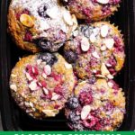Almond muffins with berries on a black serving dish.