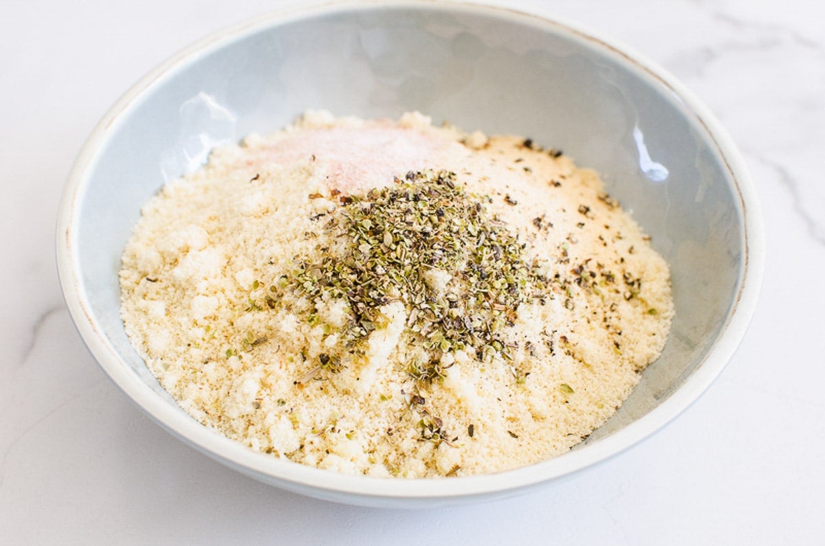 Almond flour, parmesan cheese, oregano, garlic powder, salt and pepper in a bowl.