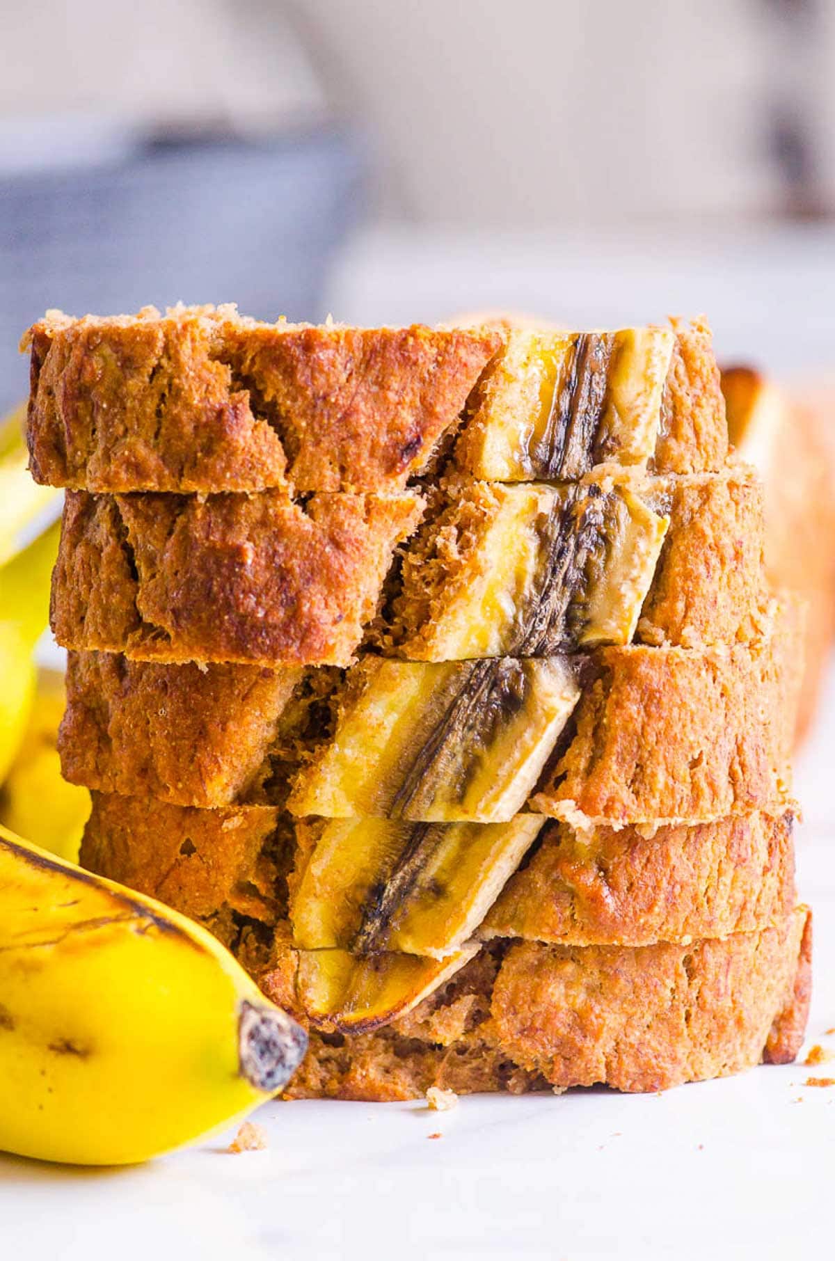 Healthy banana bread with applesauce sliced and stacked.