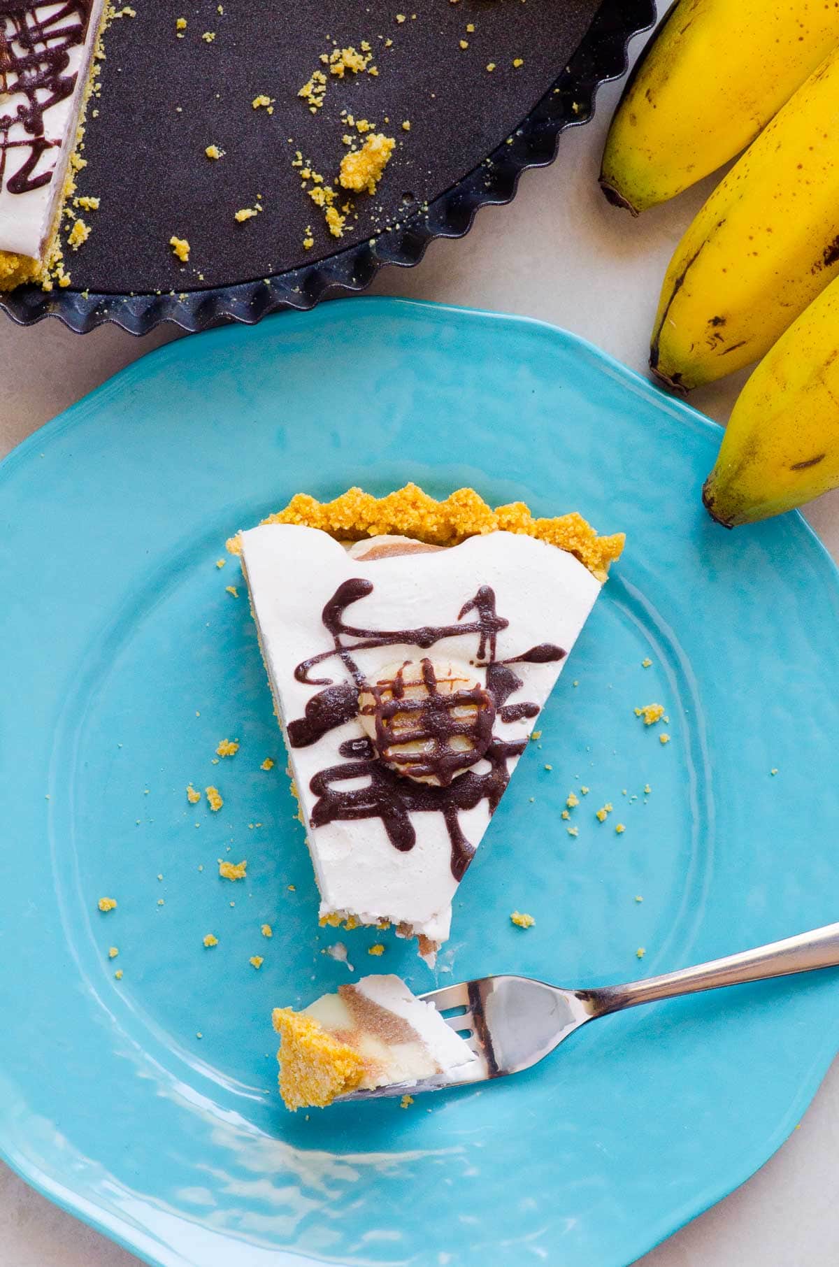 Healthy banana cream pie slice on a blue plate.