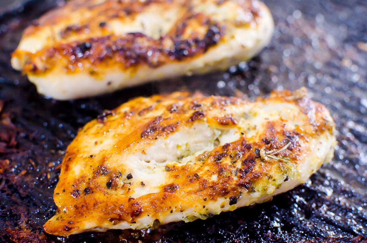 Grilled chicken breasts on a grill pan.