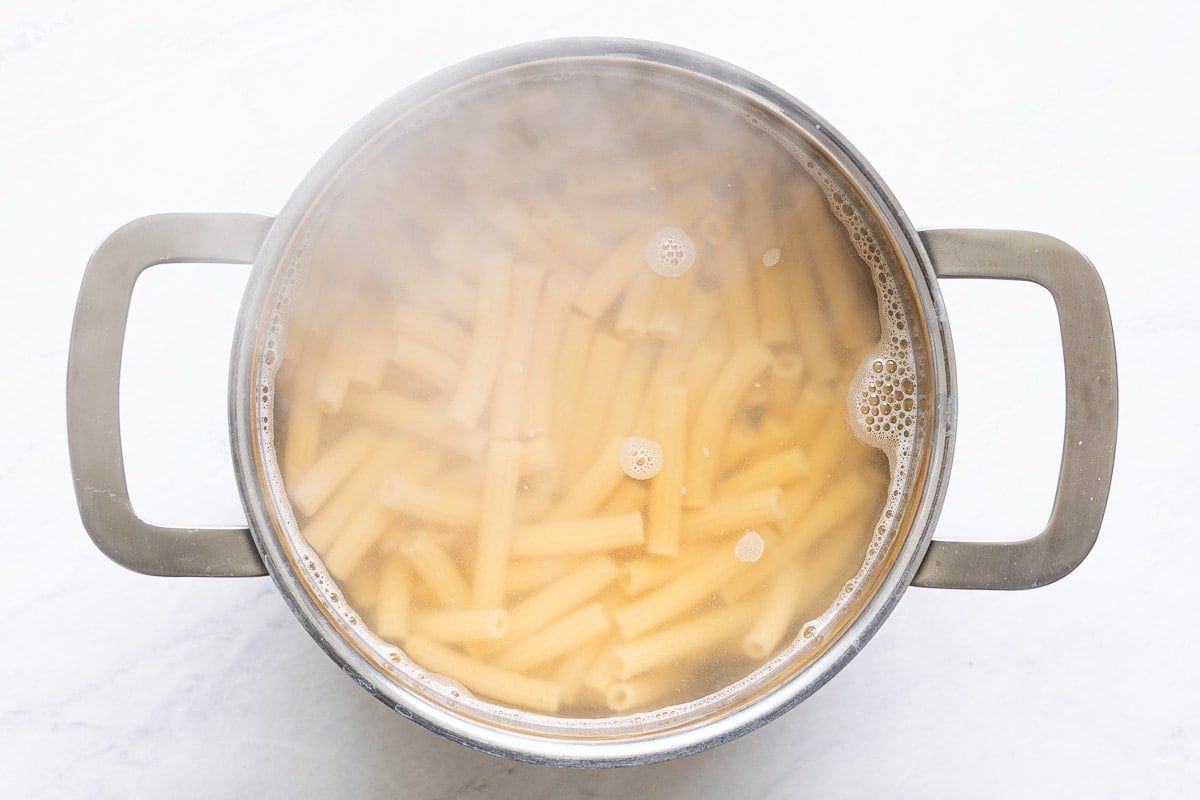 Cooked pasta in a pot with boiled water.
