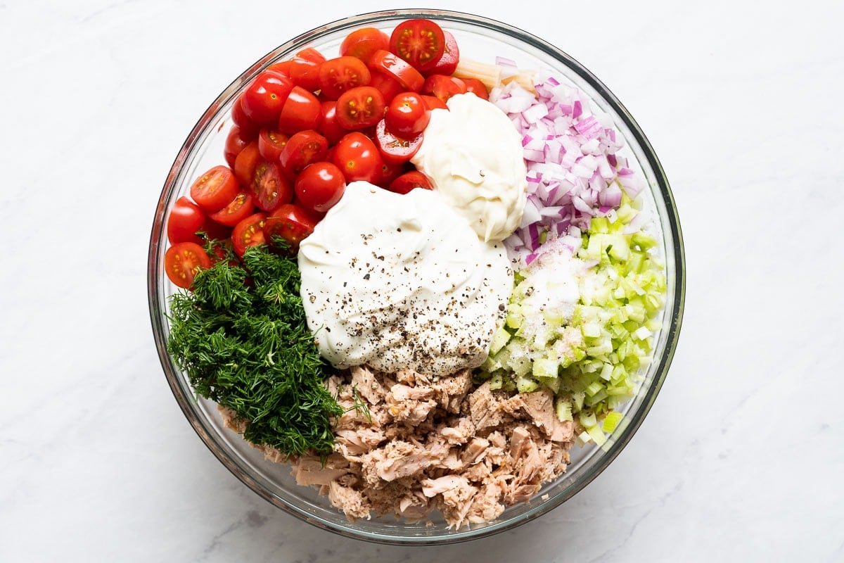 Tuna, dill, tomatoes, red onion, celery, yogurt, mayo, salt, pepper and sugar in a bowl. 