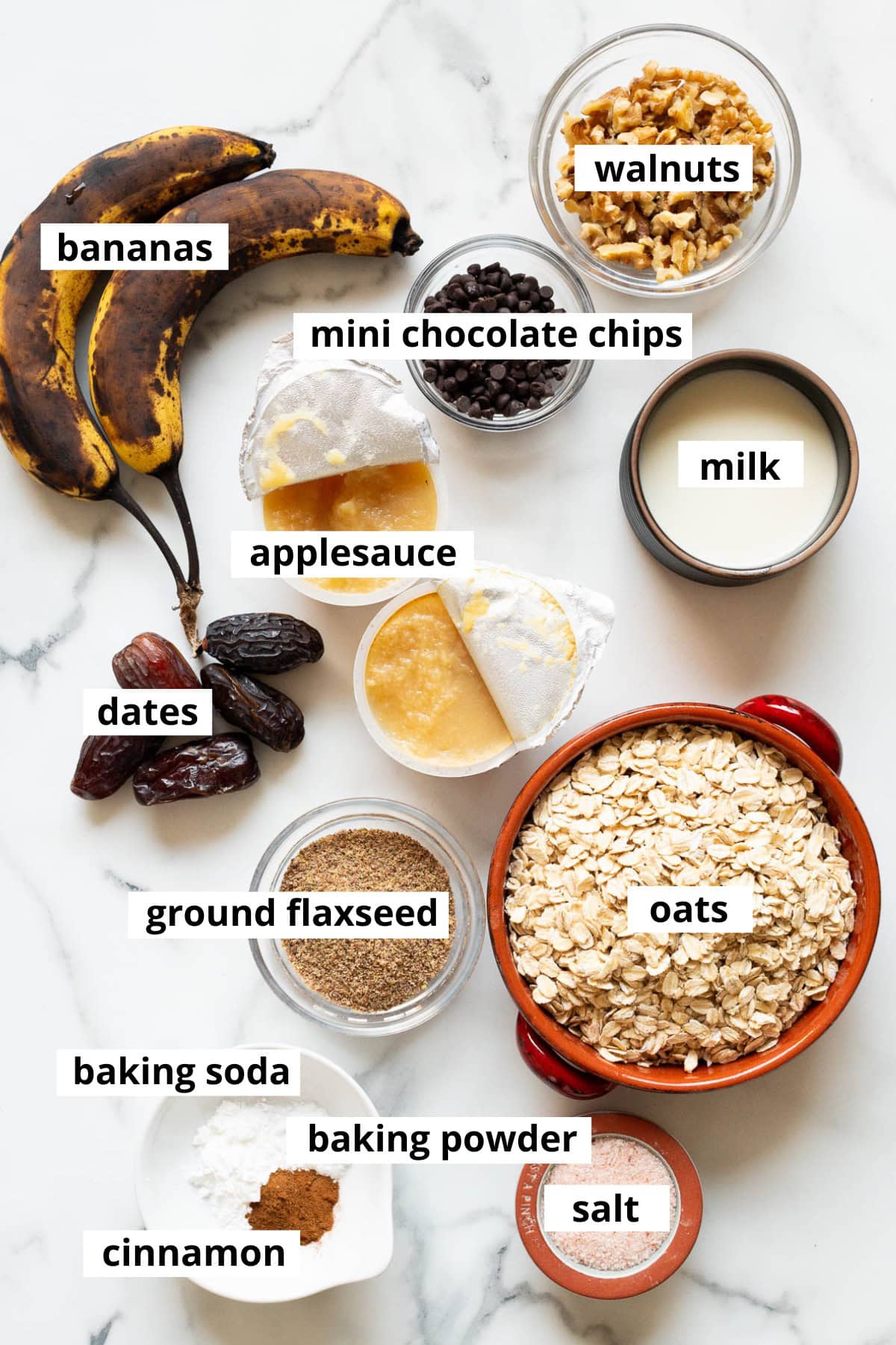 Bananas, oats, milk, walnuts, dates, mini chocolate chips, applesauce, ground flaxseed, salt, cinnamon, baking powder, baking soda.