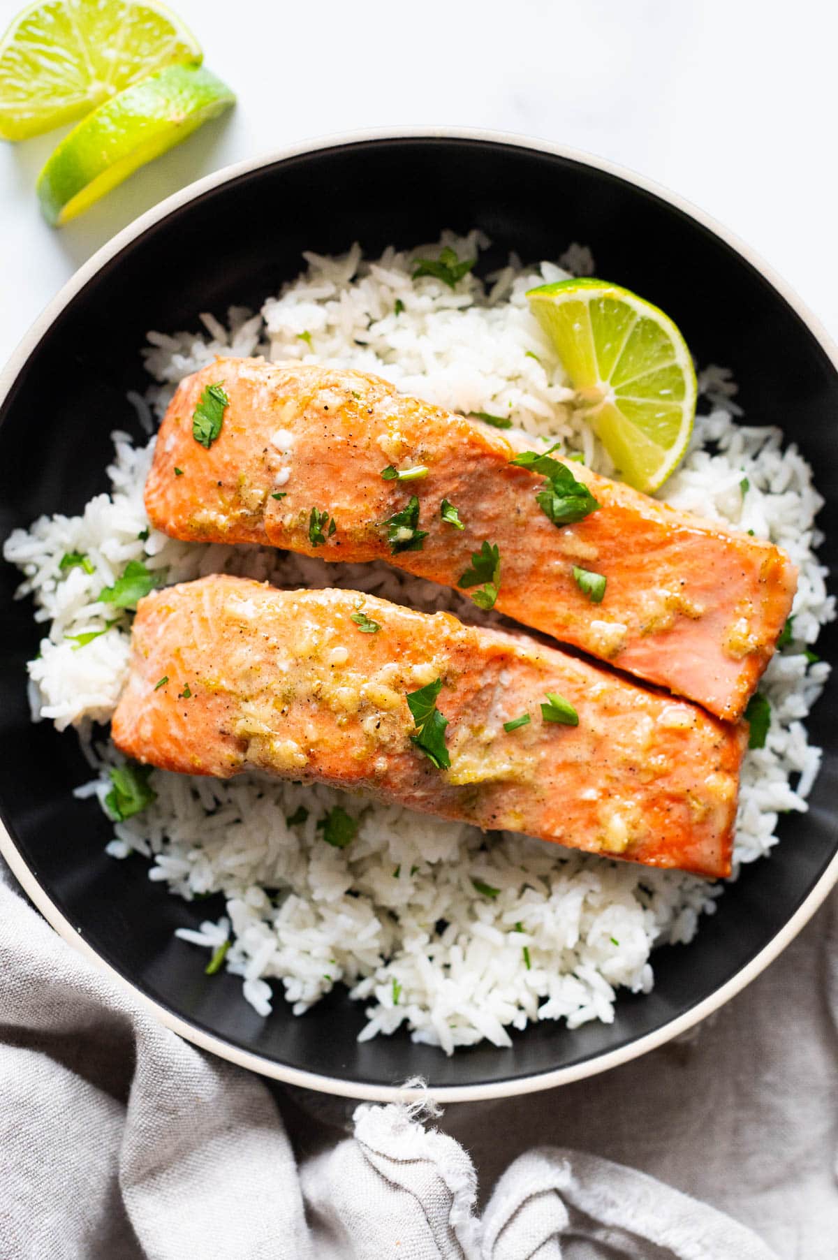 Lime salmon served over cilantro lime rice in a bowl.