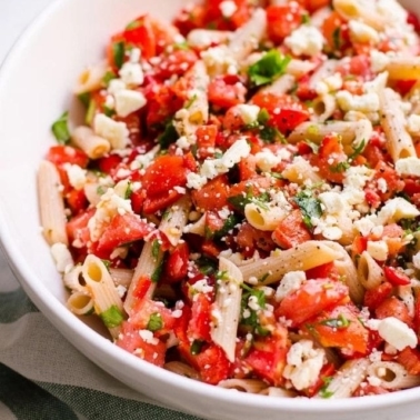 Tomato, basil and feta pasta salad in a bowl.