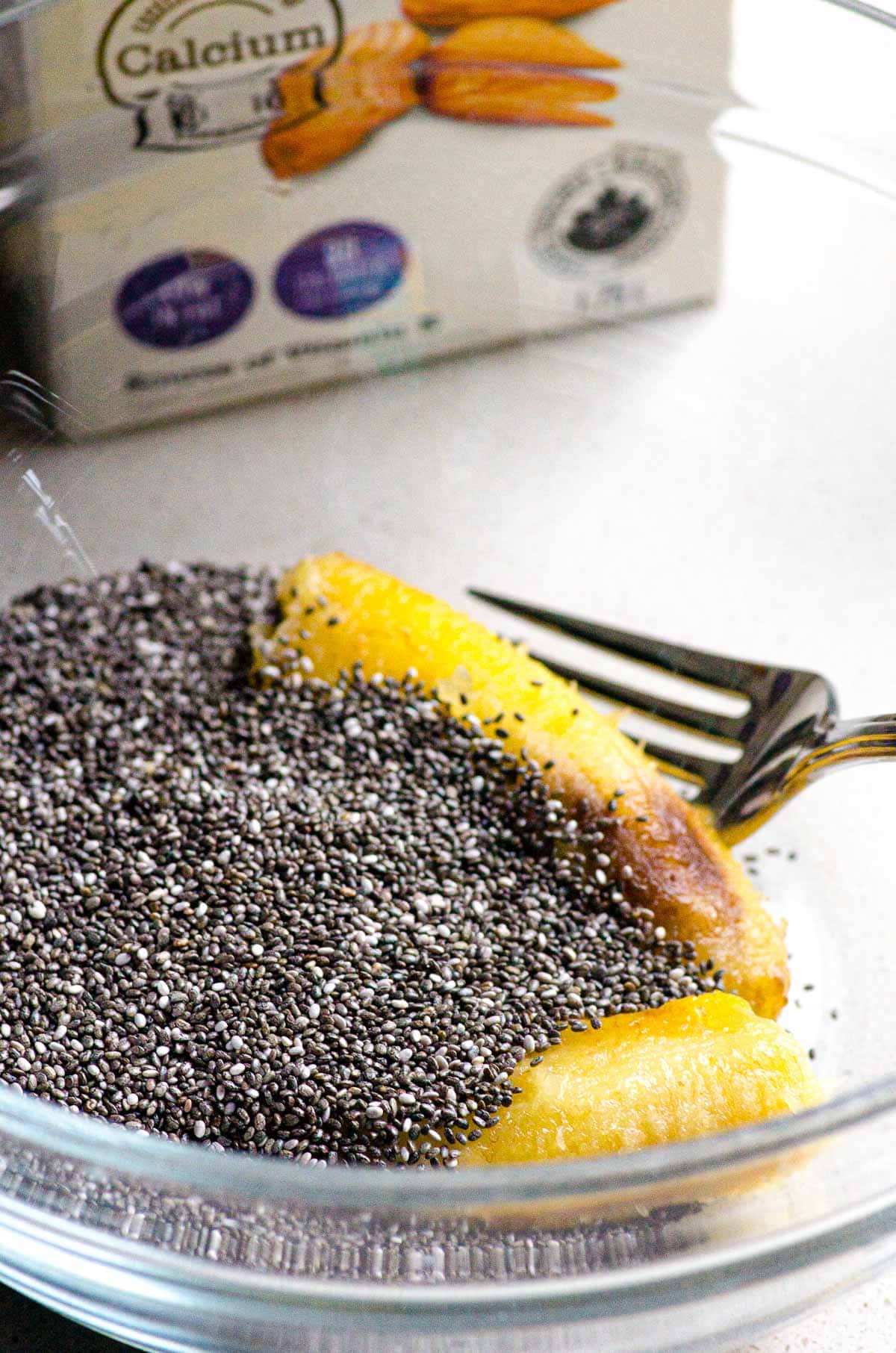 Banana and chia seeds in a bowl with the fork.