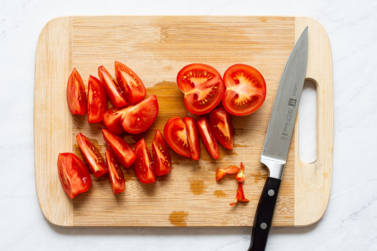Sliced tomatoes on cutting board.