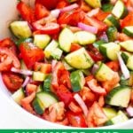 Cucumber and tomato salad in bowl.