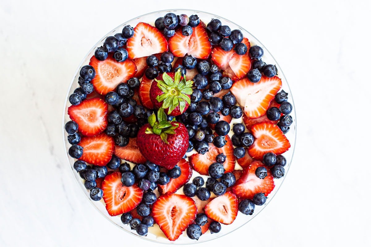 Berry trifle with blueberries and properties in a trifle bowl.