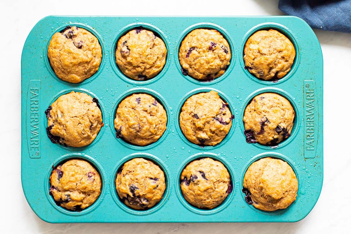 Baked muffins in blue muffin tin.