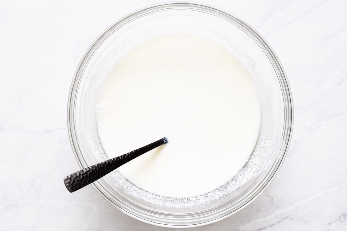 Vinegar and milk in bowl with fork.