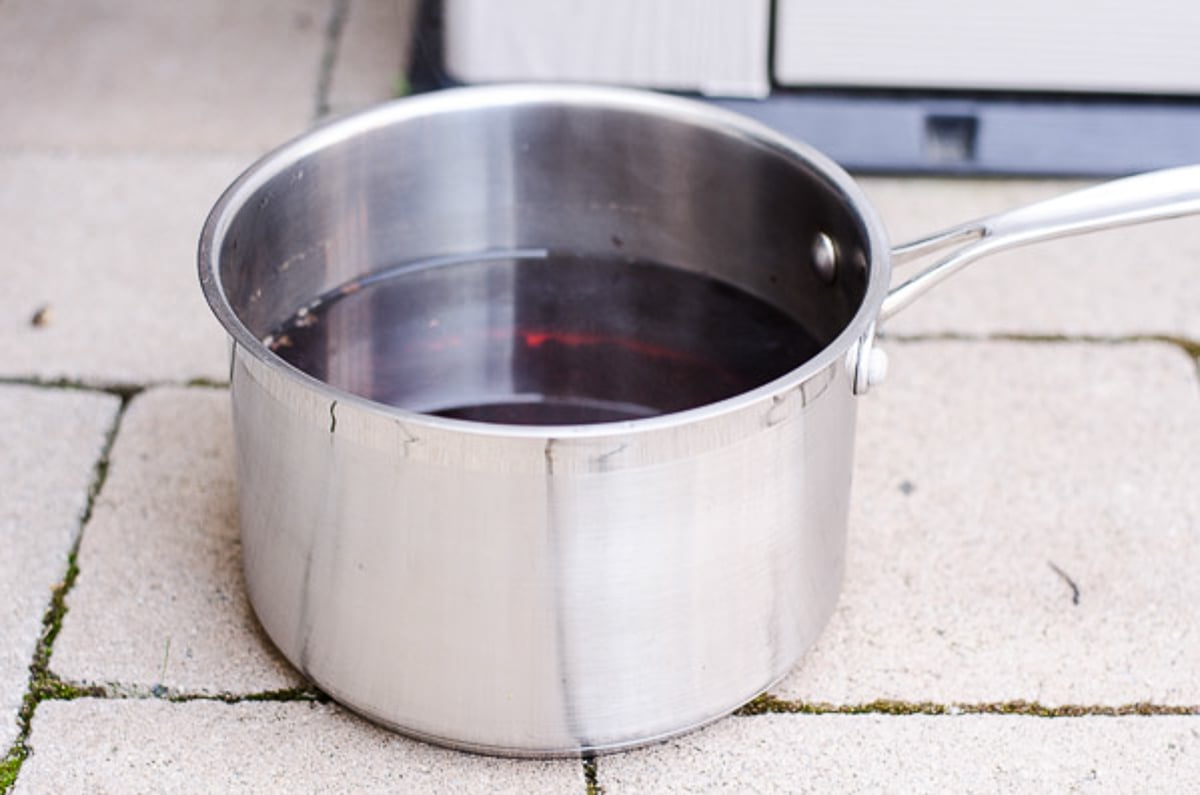 Pot with cooling iced tea on porch.