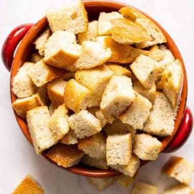 Homemade sourdough croutons in small dish.