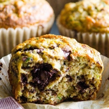 Healthy banana zucchini muffin with a bite missing.