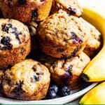 Healthy blueberry banana muffins on white platter.