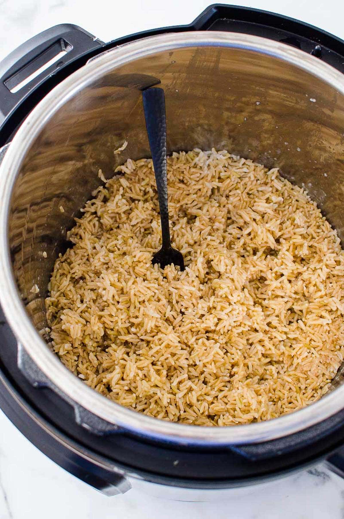 Instant Pot brown rice fluffed with a fork.