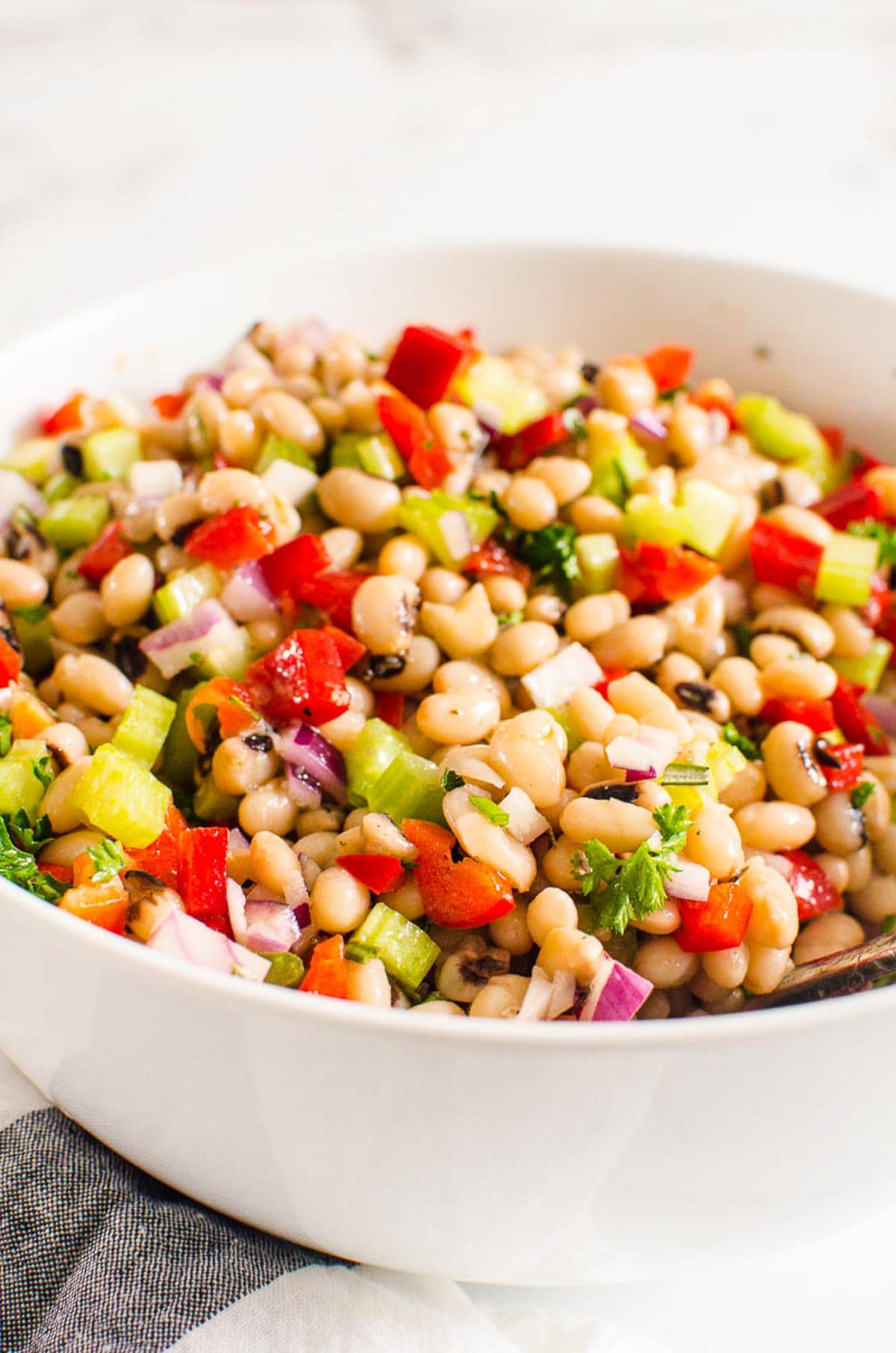 White bean salad in white bowl.