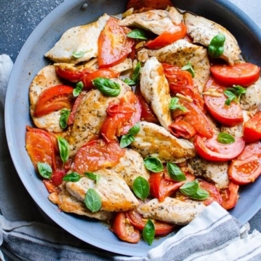 Chicken and tomatoes, garlic and basil in skillet.