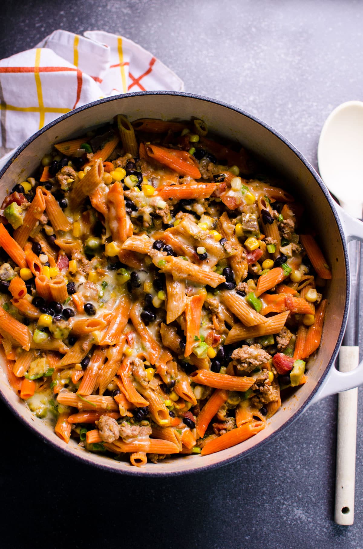 Taco pasta in a pot and spoon nearby.