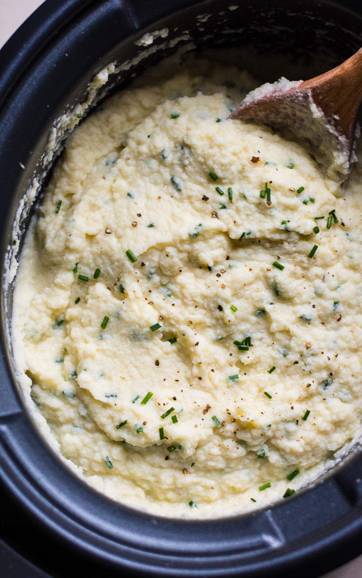 Cauliflower mashed potatoes in slow cooker with chives.