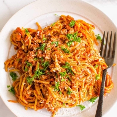 Instant Pot spaghetti on a plate with a fork.