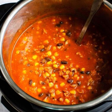 Instant Pot taco soup in pressure cooker pot with soup ladle.